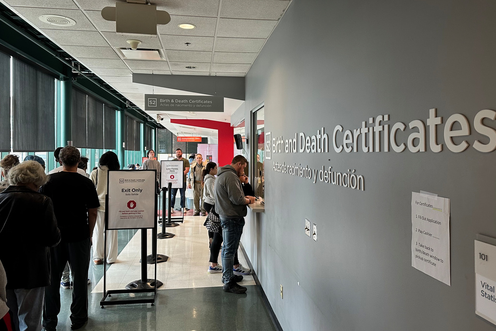 Customers stand in line to get birth and death certificates at the Columbus Public Health Department in Columbus, Ohio, on Tuesday, March, 10, 2026. (AP Photo/Julie Carr Smyth)