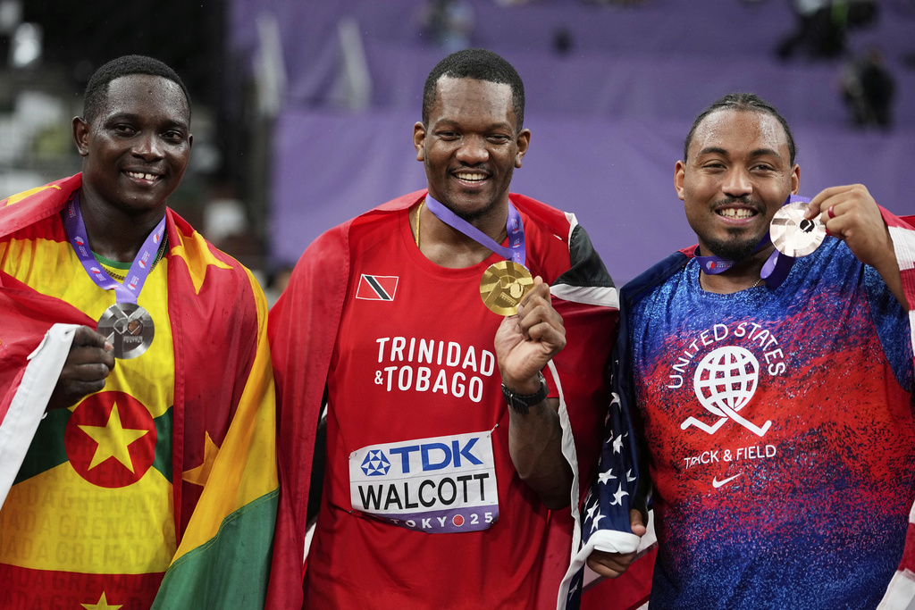 Gold medalist Trinidad And Tobago's Keshorn Walcott, centre, stands with silver medalist Grenada's Anderson Peters, left, and bronze medalist United States' Curtis Thompson following the men's javelin throw final at the World Athletics Championships in Tokyo, Thursday, Sept. 18, 2025. (AP Photo/Ashley Landis)