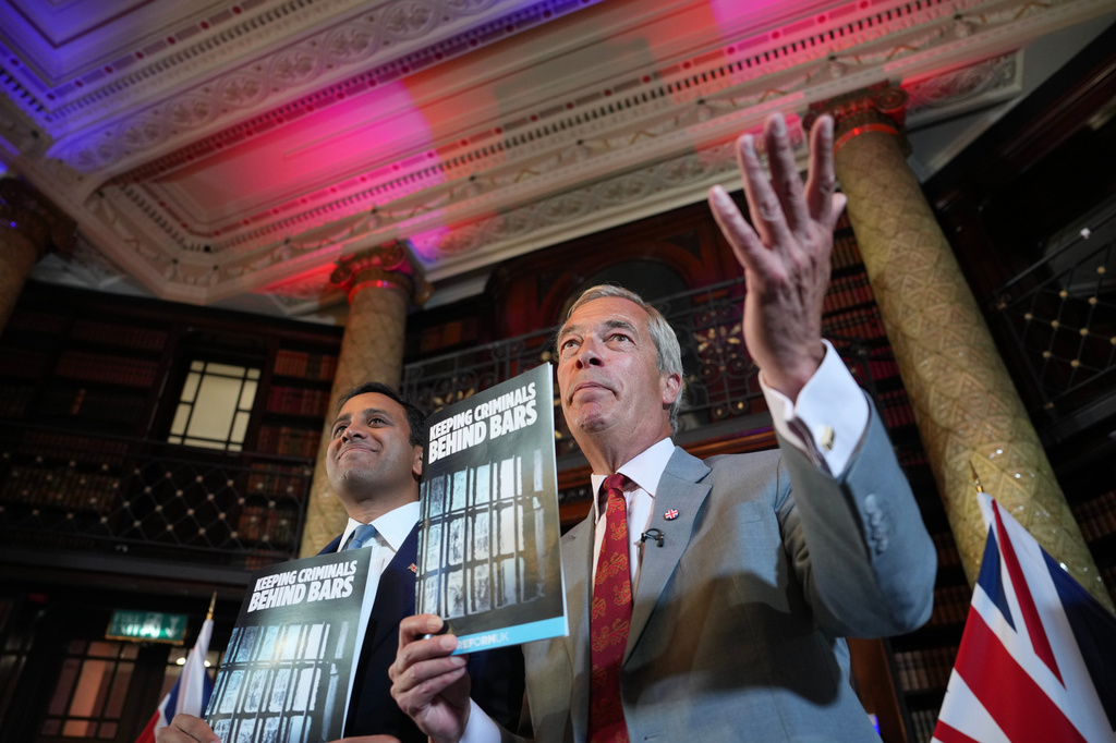 Nigel Farage, Leader of Britain's Reform UK party, right, and Zia Yusuf, Reform UK's spokesperson for home affairs attend a press conference in London, Monday, Aug. 10, 2026. (AP Photo/Kin Cheung)