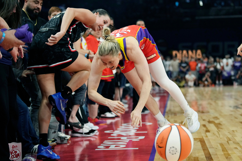 Phoenix Mercury guard Sami Whitcomb, right, and Portland Fire forward Bridget Carleton, left, collide as they try to get to the basketball during the first half of a WNBA basketball game Sunday, Aug. 16, 2026, in Phoenix. (AP Photo/Ross D. Franklin)
