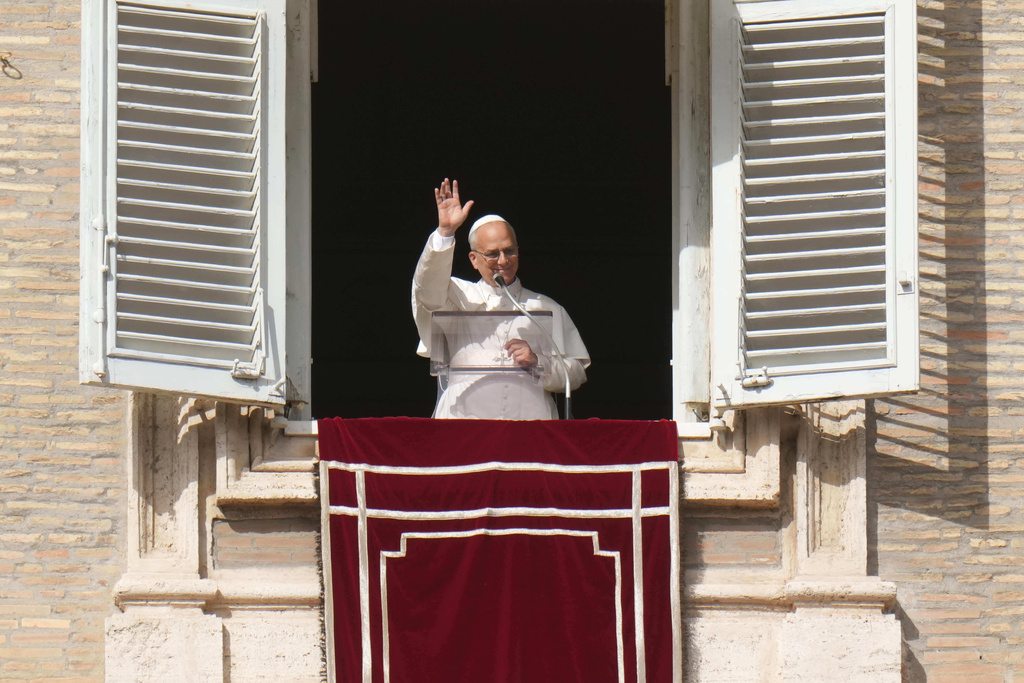 Pope Leo XIV delivers his blessing as he recites the Angelus noon prayer from the window of his studio overlooking St.Peter's Square, at the Vatican, Sunday, Oct. 26, 2025. (AP Photo/Alessandra Tarantino)