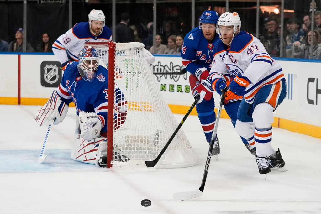 New York Rangers goaltender Igor Shesterkin (31) watches as Edmonton Oilers' Connor McDavid (97) looks to pass during the first period of an NHL hockey game Tuesday, Oct. 14, 2025, in New York. (AP Photo/Frank Franklin II)