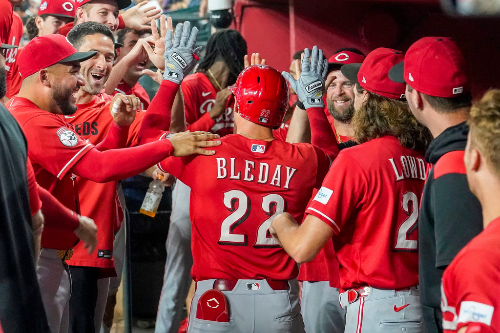Cincinnati Reds' JJ Bleday, center, gets high-fives from teammates after hitting for the cycle during the sixth inning of a baseball game against the Arizona Diamondbacks, Saturday, Aug. 22, 2026, in Phoenix. (AP Photo/Darryl Webb)