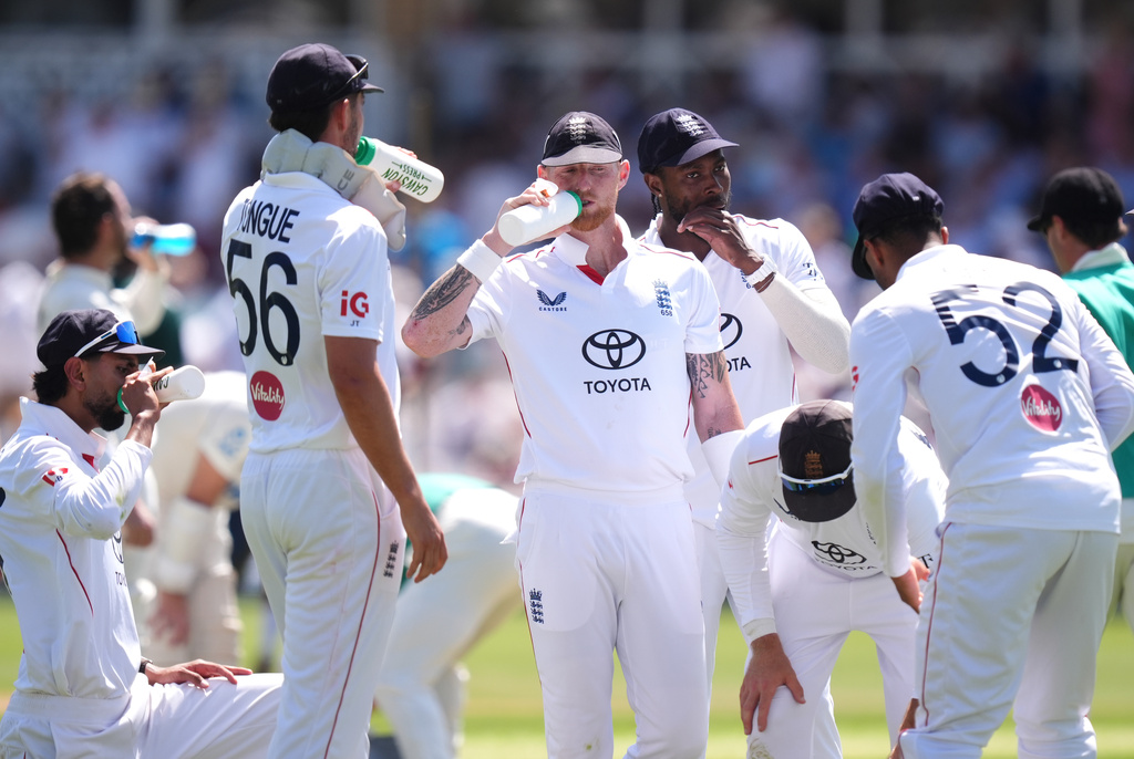 England's Ben Stokes, center and teammates take a drinks break during day one of the Third Test cricket match between England and New Zealand, in Nottingham, England, Thursday June 25, 2026. (Mike Egerton/PA via AP)