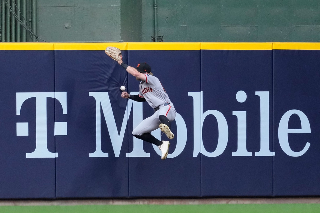 San Francisco Giants' Jonah Cox is unable to catch a ball hit by Milwaukee Brewers' Brice Turang during the second inning of a baseball game Monday, June 1, 2026, in Milwaukee. (AP Photo/Aaron Gash)