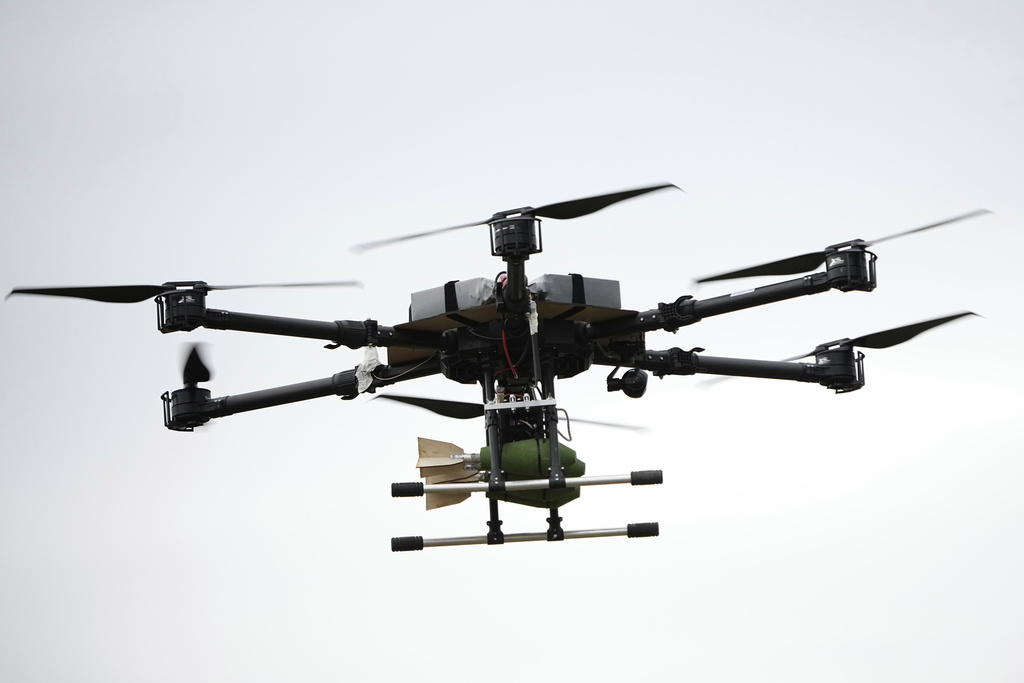 A drone carrying a bomb flies over during joint Russian-Belarusian military drills at a training ground near Barysaw, Belarus, Monday, Sept. 15, 2025. (AP Photo/Pavel Bednyakov)
