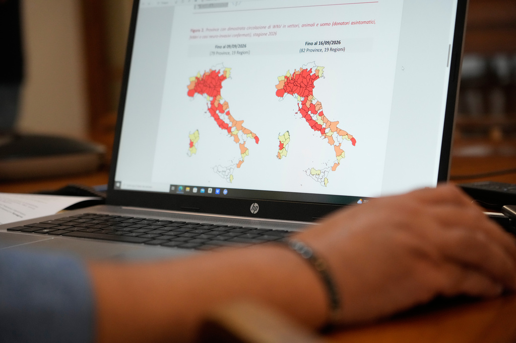 Antonino Bella, senior researcher at the Infectious Diseases Department of the Italian National Institute of Health, checks a map of Italy showing provinces with confirmed circulation of West Nile virus (WNV) in vectors, animals, and humans for the 2026 season, in Rome, Friday, Sept. 18, 2026. (AP Photo/Gregorio Borgia)