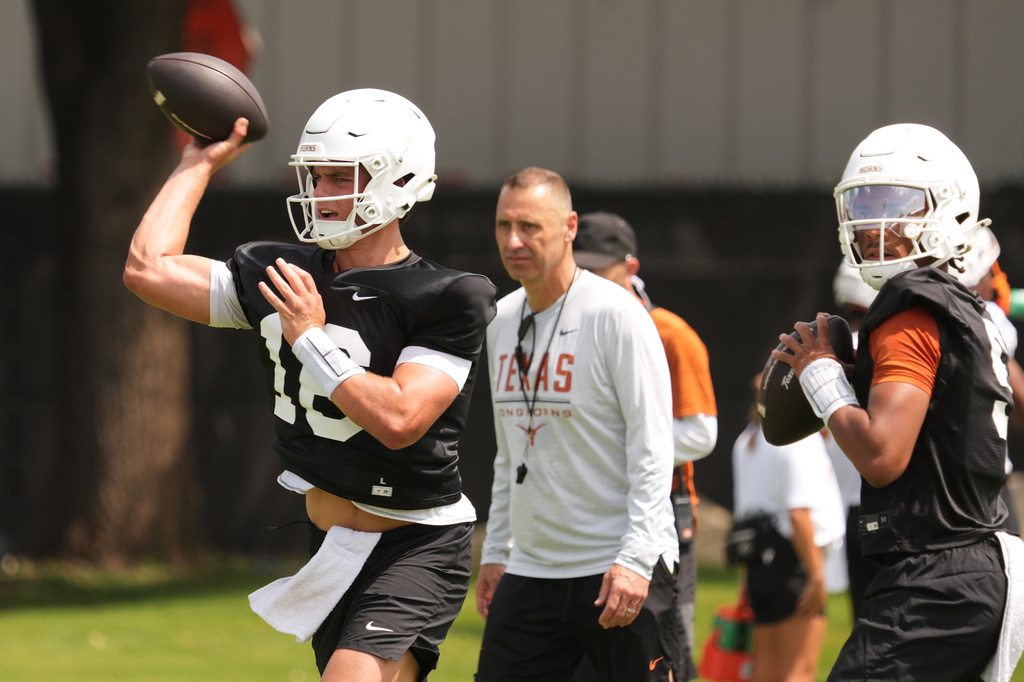 Texas quarterback Arch Manning (16) throws during an NCAA college preseason football camp in Austin, Texas, Wednesday, Aug. 5, 2026. (AP Photo/Eric Gay)