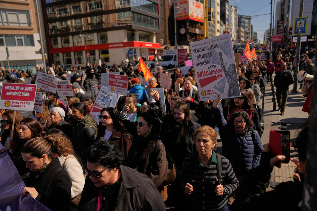 Women march during a protest marking the International Women's Day, in Istanbul, Turkey, Sunday, March 8, 2026. Placard reads in Turkish: "We fight against poverty, violence, and war!". (AP Photo/Khalil Hamra)