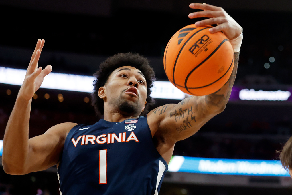 Virginia's Malik Thomas (1) grabs a rebound against North Carolina State during the first half of an NCAA college basketball game in Raleigh, N.C., Saturday, Jan. 3, 2026. (AP Photo/Karl DeBlaker)
