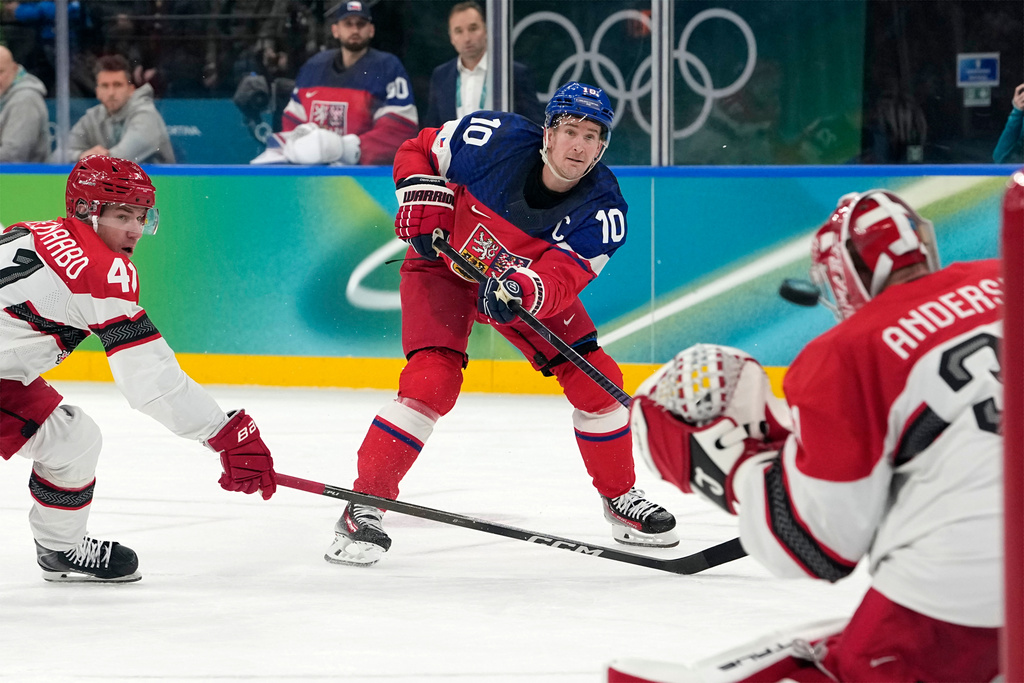 Czechia's Roman Cervenka (10) scores a goal against Denmark goalkeeper Frederik Andersen (31) during the second period of a men's ice hockey qualification playoff game at the 2026 Winter Olympics, in Milan, Italy, Tuesday, Feb. 17, 2026. (AP Photo/Hassan Ammar)