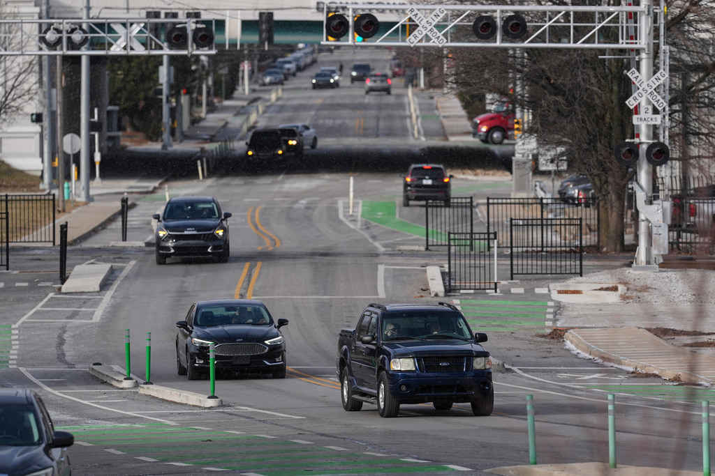 Cars make their way onto the recently converted two-way portion of Michigan Street in Indianapolis, Thursday, Jan. 15, 2026. (AP Photo/Michael Conroy)
