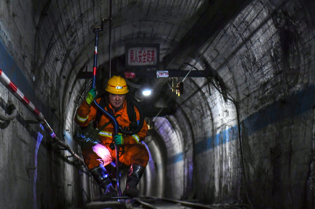 In this photo released by Xinhua News Agency, a rescuer comes up from the coal mine shaft after conducting search and rescue operation following a gas explosion at the Liushenyu coal mine facility in Qinyuan county in Changzhi, northern China's Shanxi province on Sunday, May 24, 2026. (Cao Yang/Xinhua via AP)
