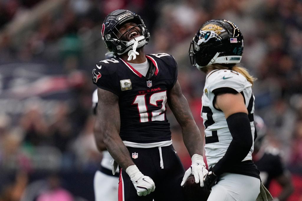 Houston Texans wide receiver Nico Collins (12) celebrates a complete pass during the second half of an NFL football game, Sunday, Nov. 9, 2025, in Houston. (AP Photo/Ashley Landis)