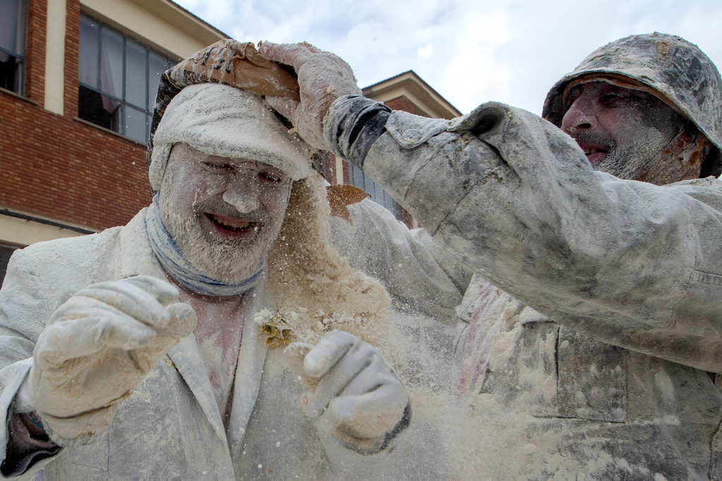 Revellers take part in the Els Enfarinats festival, a battle using flour, eggs and firecrackers, in the town of Ibi near Alicante, Spain, Sunday Dec. 28, 2025. (AP Photo/Alberto Saiz)