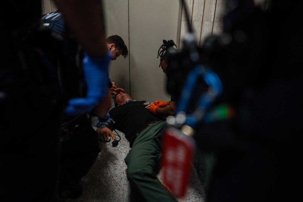 Journalist L. Vural Elibol receives medical assistance after being shoved by federal agents in immigration court on Tuesday, Sept. 30, 2025, in New York. (AP Photo/Olga Fedorova)