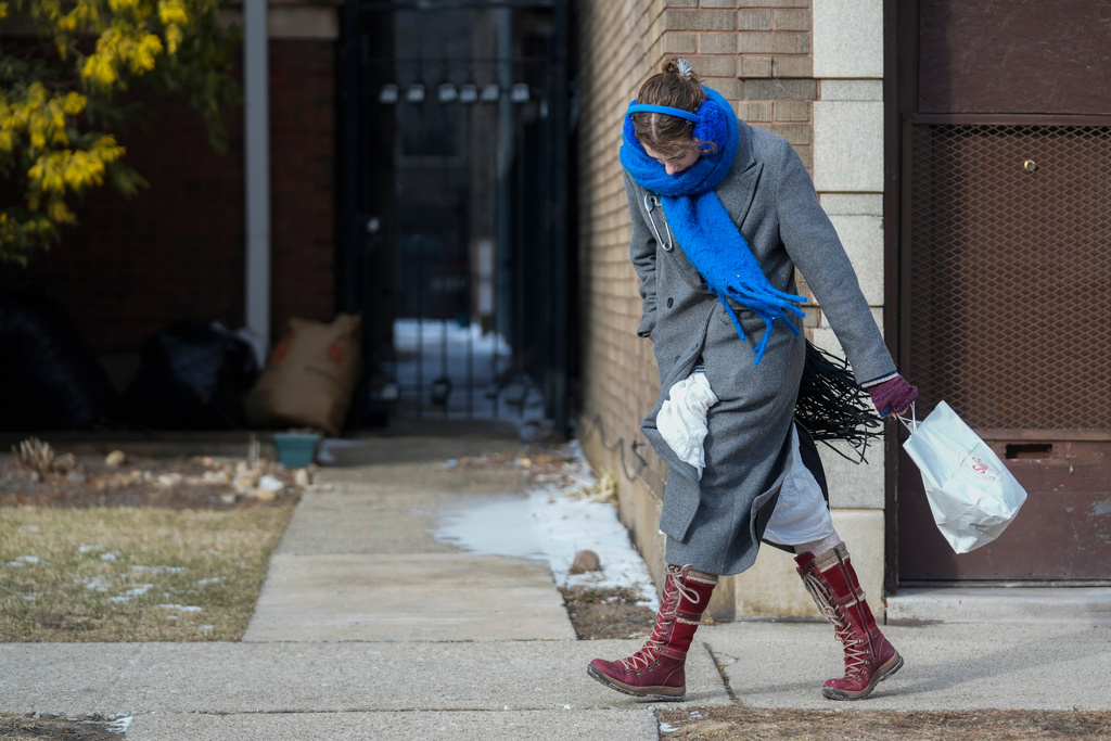 A person walks in the cold and wind Wednesday, Jan. 21, 2026, in Chicago. (AP Photo/Erin Hooley)