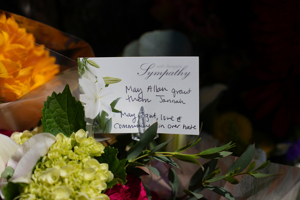 FILE - A note attached to flowers is placed outside of the Islamic Center of San Diego, the day after a shooting, May 19, 2026, in San Diego. (AP Photo/Jae C. Hong, File)