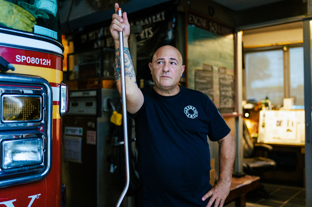 Firefighter Sal Argano, Ladder 10, poses for a portrait at FDNY "Ten House" near Ground Zero on Friday, Aug. 7, 2026, in New York. (AP Photo/Angelina Katsanis)