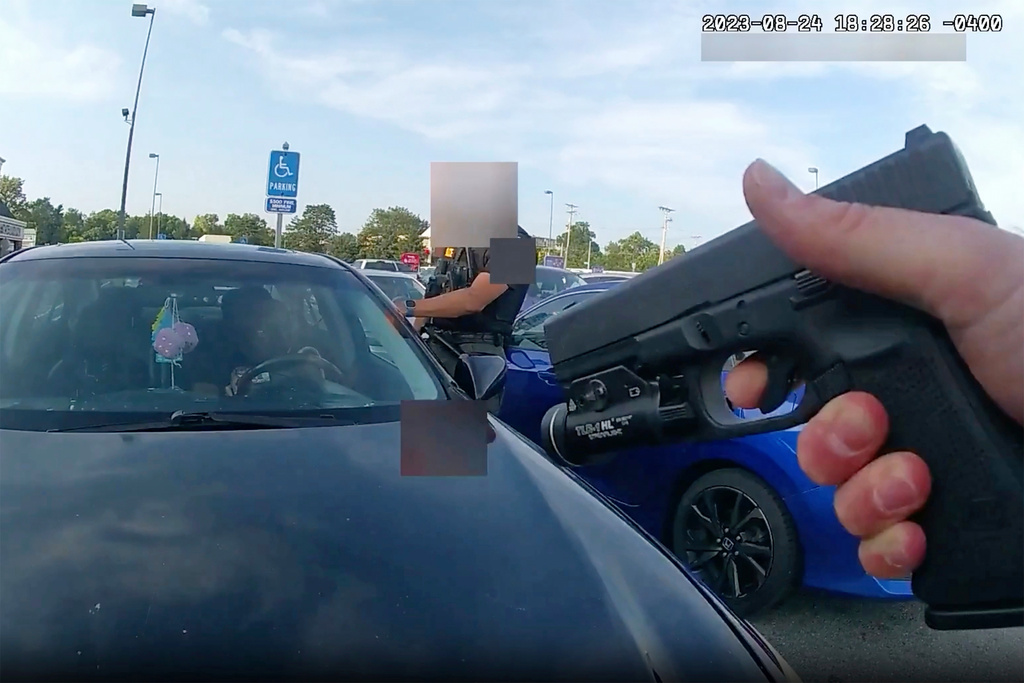 FILE - This still image from bodycam video released by the Blendon Township Police on Sept. 1, 2023, shows an officer pointing his gun at Ta'Kiya Young moments before shooting her through the windshield outside a grocery store in Blendon Township, Ohio, a suburb of Columbus, on Aug. 24. The video was pixelated by the source. (Blendon Township Police via AP, File)