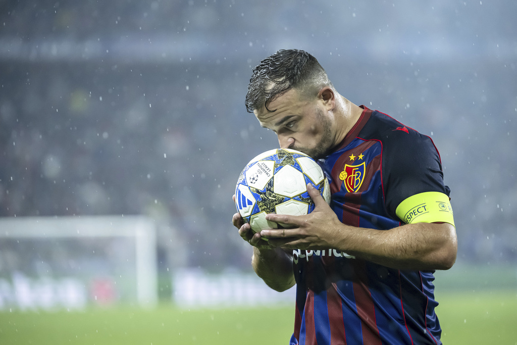 Basel's Xherdan Shaqiri kisses the ball during the UEFA Champions League playoff first leg match between Switzerland's FC Basel 1893 and Denmark's F.C. Copenhagen at the St. Jakob-Park stadium in Basel, Switzerland, on Wednesday, Aug. 20, 2025. (Georgios Kefalas/Keystone via AP)