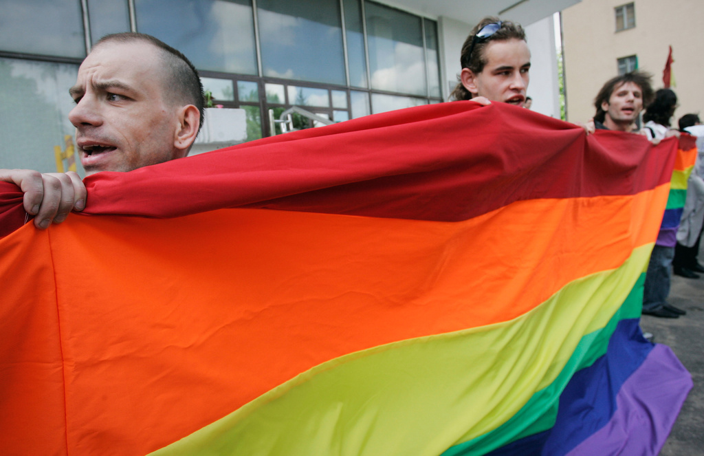 FILE - Activists hold a rainbow flag as they march during a pride parade in Minsk, Belarus, Saturday, May 15, 2010. (AP Photo, File)