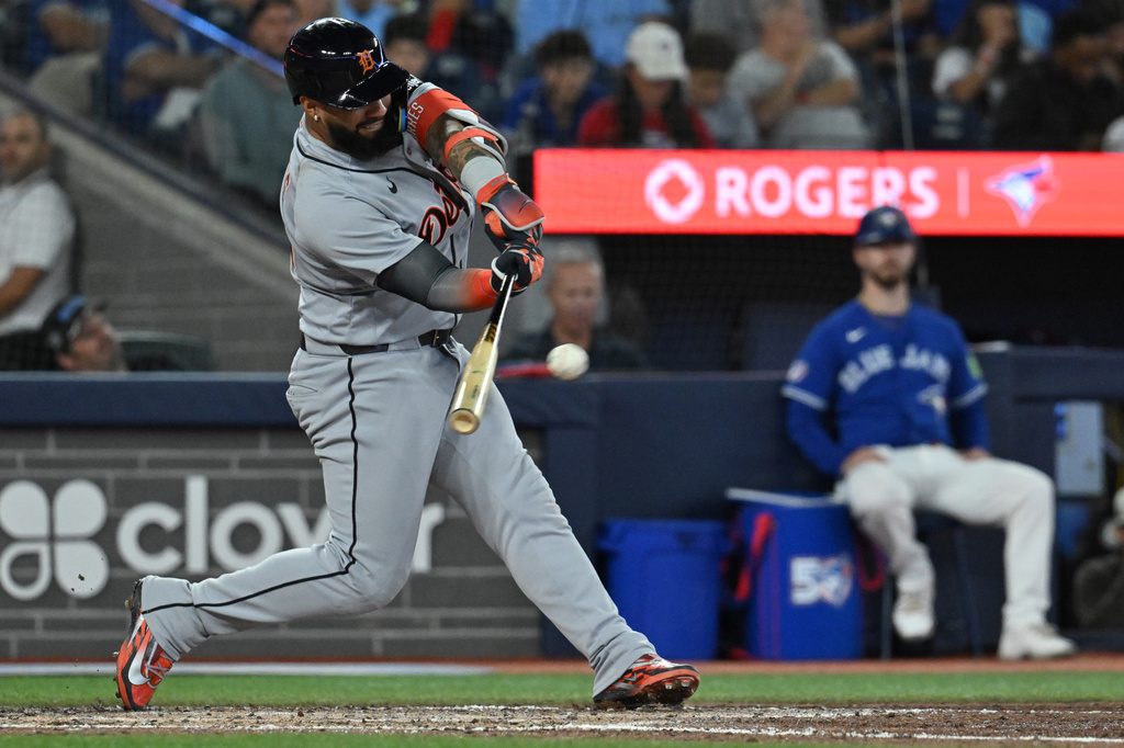 Detroit Tigers second baseman Gleyber Torres (25) hits a single against the Toronto Blue Jays during the seventh inning of a baseball game in Toronto on Monday, Sept. 14, 2026. (Jon Blacker/The Canadian Press via AP)