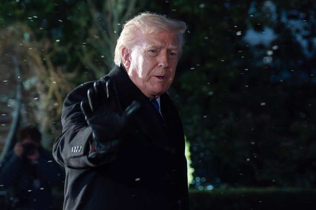 President Donald Trump speaks to reporters on the South Lawn before departing the White House, Friday, Feb. 6, 2026, in Washington. (AP Photo/Jose Luis Magana)