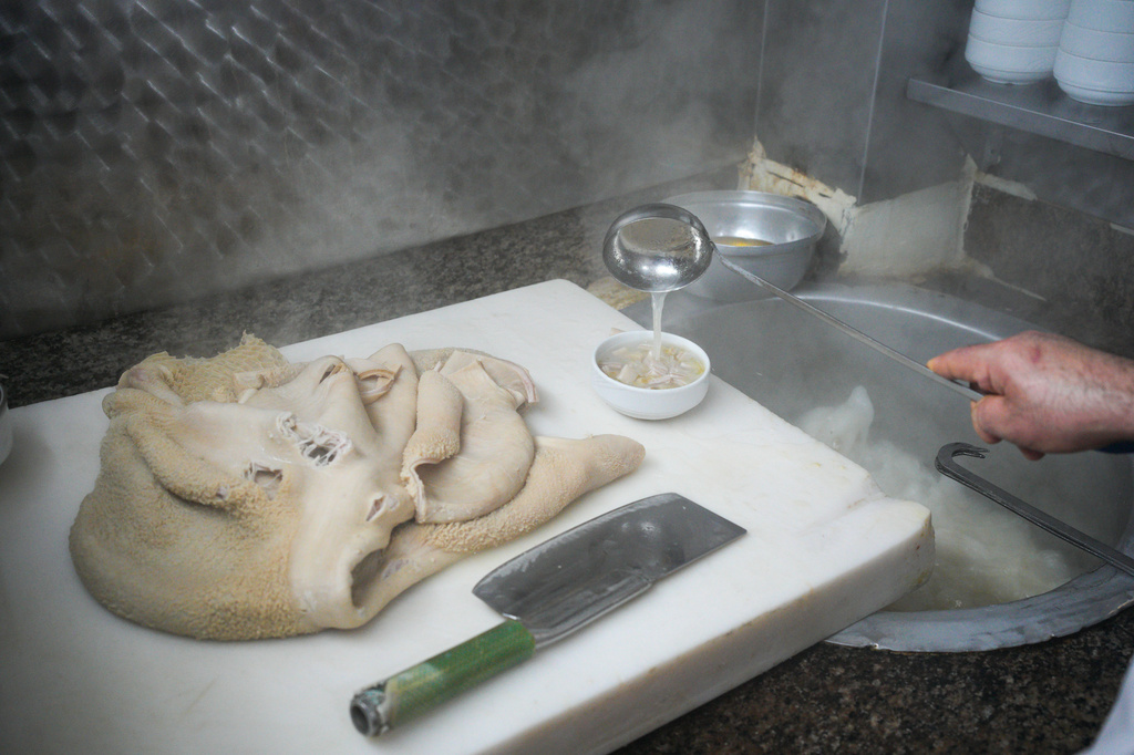 A man cooks traditional tripe soup, known as "iskembe" in Turkish and "patsas" in Greek, in a restaurant in Istanbul, Turkey, Friday, March 27, 2026. (AP Photo/Emrah Gurel)