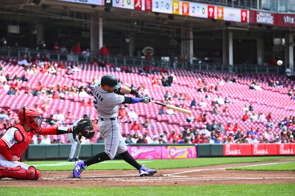 Colorado Rockies' Tyler Freeman (2) hits a two-run home run during the first inning of a baseball game against the Cincinnati Reds in Cincinnati, Thursday, April 30, 2026. (AP Photo/Ben Jackson)