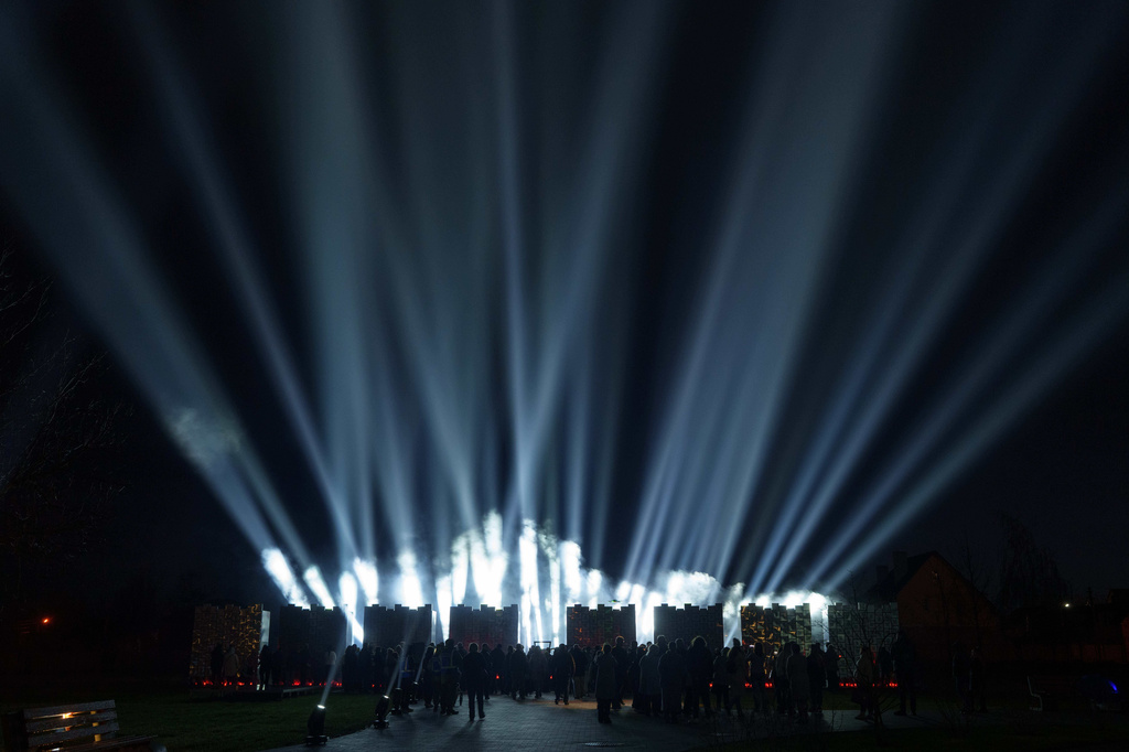 People attend a ceremony at a memorial for killed civilians to mark the fourth anniversary of the liberation of Bucha, Ukraine, on Monday, March 30, 2026. (AP Photo/Evgeniy Maloletka)