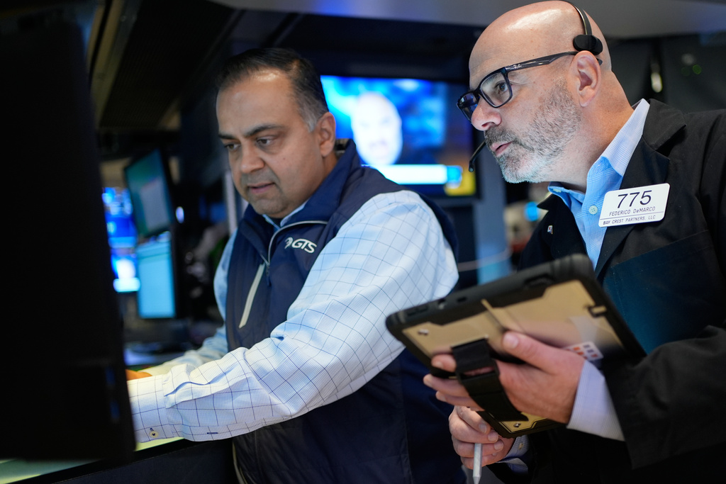 Federico DeMarco, right, and Dilip Patel work on the floor at the New York Stock Exchange in New York, Wednesday, March 25, 2026. (AP Photo/Seth Wenig)