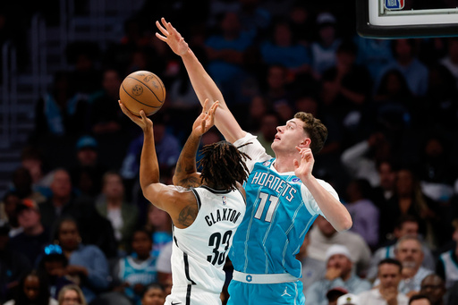 Charlotte Hornets center Ryan Kalkbrenner (11) disrupts the shot attempt of Brooklyn Nets center Nic Claxton during the first half of an NBA basketball game in Charlotte, N.C., Wednesday, Oct. 22, 2025. (AP Photo/Nell Redmond) Charlotte Hornets center Ryan Kalkbrenner (11) disrupts the shot attempt of Brooklyn Nets center Nic Claxton during the first half of an NBA basketball game in Charlotte, N.C., Wednesday, Oct. 22, 2025. (AP Photo/Nell Redmond)