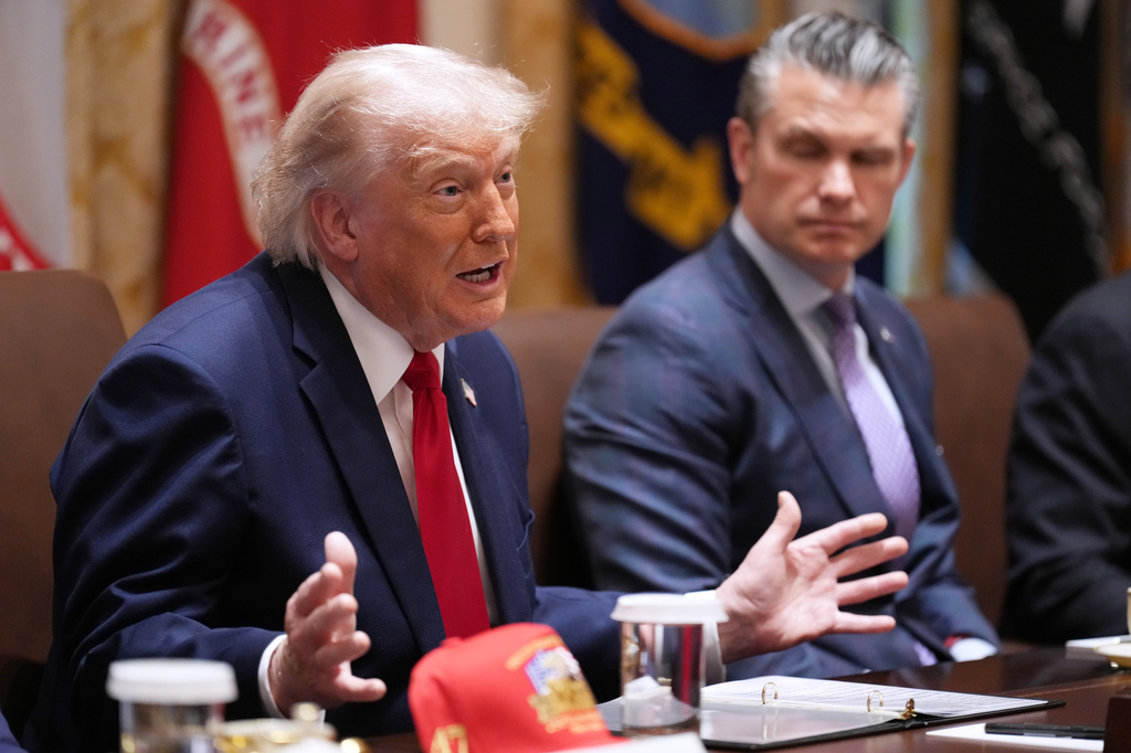 President Donald Trump speaks during a Cabinet meeting at the White House, Wednesday, May 27, 2026, in Washington, as Secretary of Defense Pete Hegseth, looks on. (AP Photo/Jacquelyn Martin)