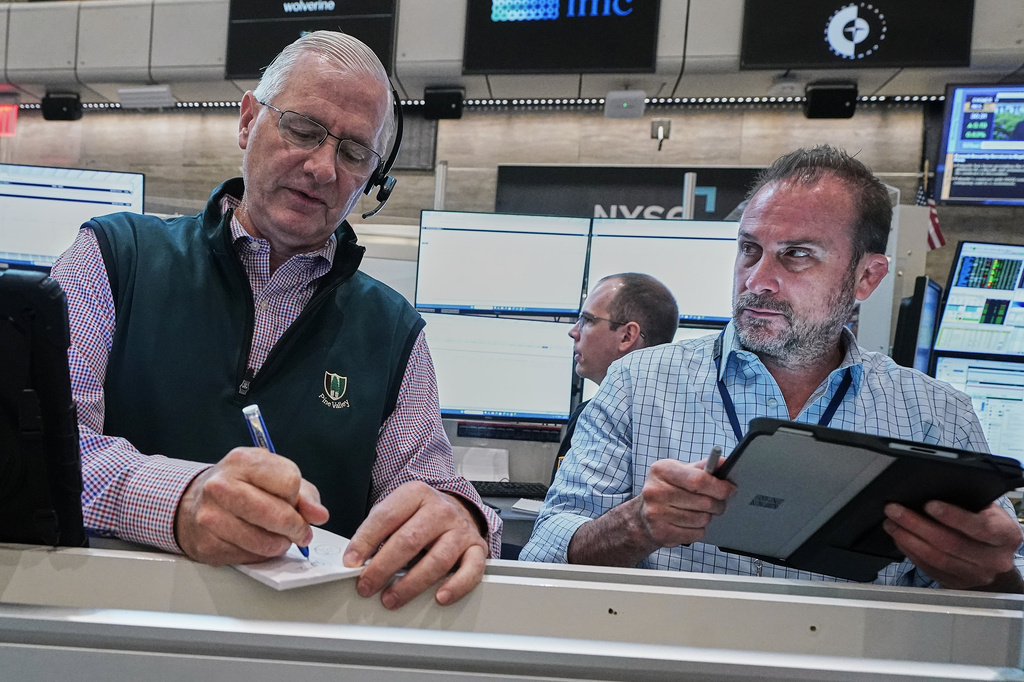 Options traders David Rush, left, and Scott Frinzi work on the floor of the New York Stock Exchange, Tuesday, June 16, 2026. (AP Photo/Richard Drew)