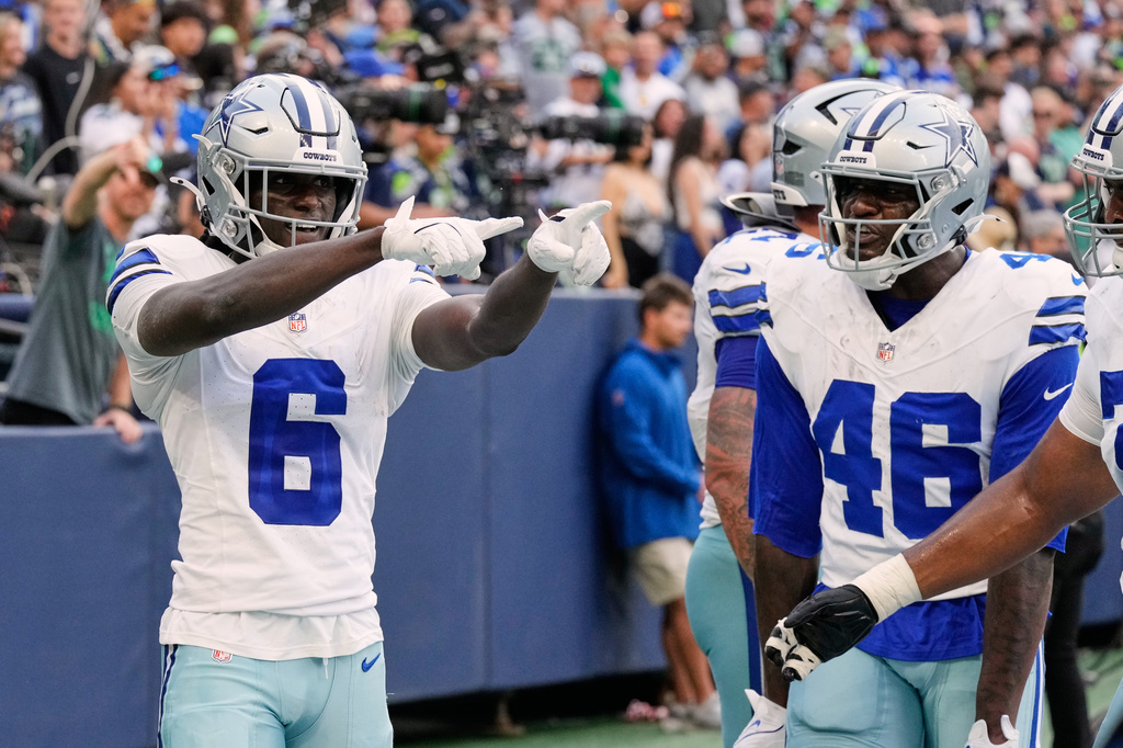 Dallas Cowboys wide receiver Camden Brown (6), Michael Trigg (46) and others celebrate Brown's touchdown catch in the second half of an NFL preseason football game against the Seattle Seahawks, Saturday, Aug. 15, 2026, in Seattle. (AP Photo/Stephen Brashear)