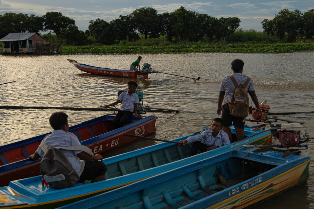 Students board school boats to return to their homes in a floating village on Cambodia's Tonle Sap Lake on Monday, June 29, 2026. (AP Photo/Anton L. Delgado)