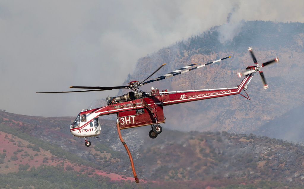 A Sikorsky Skycrane rises after refilling during efforts to fight the Widemouth 2 Fire east of Fillmore, Utah, on Tuesday, Aug. 4, 2026, before it crashed on Friday, Aug. 7. (Scott G Winterton/The Deseret News via AP)