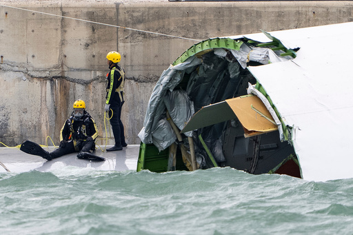 A diver prepares to inspect the cargo aircraft that skidded off a Hong Kong runway on Monday, Oct. 20, 2025. (AP Photo/Chan Long Hei) A diver prepares to inspect the cargo aircraft that skidded off a Hong Kong runway on Monday, Oct. 20, 2025. (AP Photo/Chan Long Hei)
