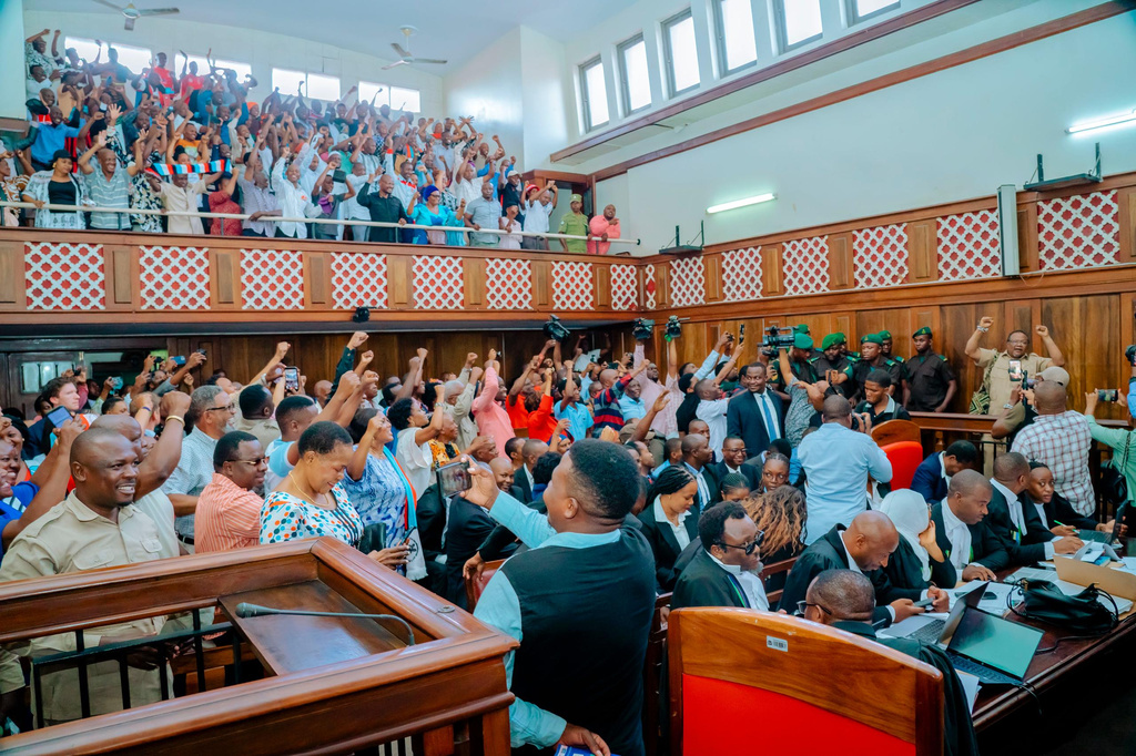 Main opposition leader Tundu Lissu, far right, gestures with supporters at the High Court of Tanzania as his treason trial continues before a three-judge bench in Dar es Salaam, Tanzania, Monday, Feb 9, 2026. (AP Photo/Florence Majani)