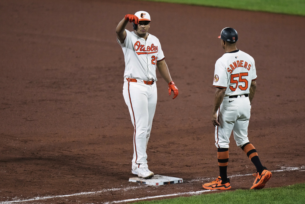 Baltimore Orioles' Sam Basallo, left, celebrates after hitting a single during the sixth inning of a baseball game against the Houston Astros, Thursday, Aug. 21, 2025, in Baltimore. (AP Photo/Stephanie Scarbrough)