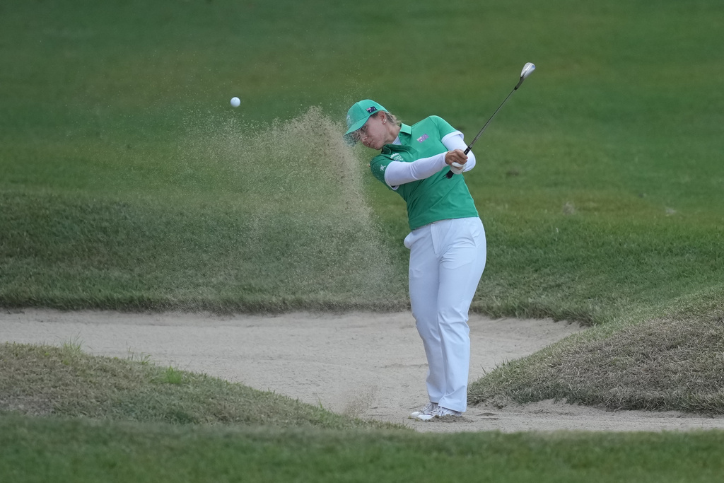 Steph Kyriacou of Australia hits out of a bunker on the first hole during the pool A match against Thailand team for the LPGA International Crown golf tournament at the New Korea Country Club in Goyang, South Korea, Thursday, Oct. 23, 2025. (AP Photo/Lee Jin-man)