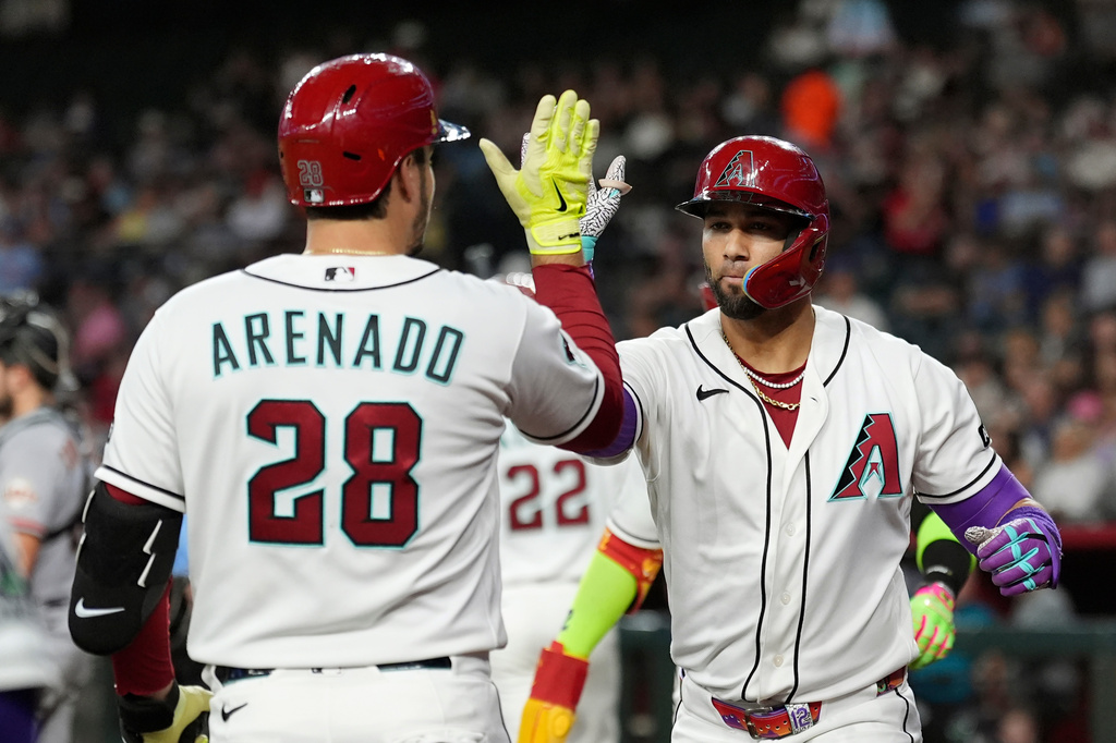 Arizona Diamondbacks' Lourdes Gurriel Jr., right, celebrates his three-run home run against the San Francisco Giants with Diamondbacks' Nolan Arenado (28) during the first inning of a baseball game, Tuesday, June 30, 2026, in Phoenix. (AP Photo/Ross D. Franklin)