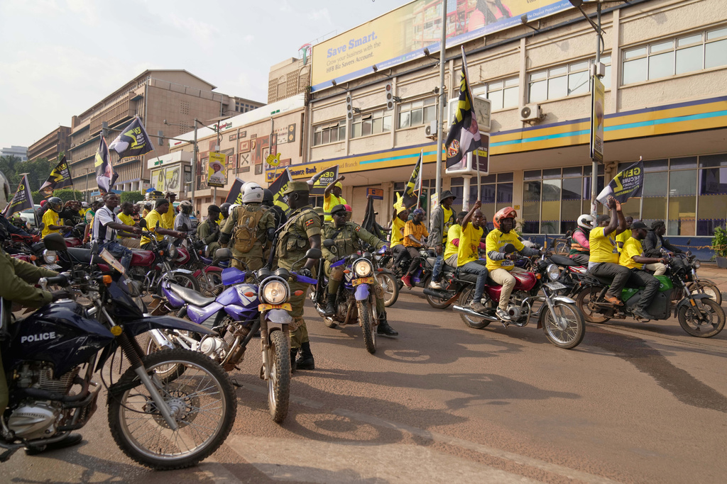 Uganda's security forces patrol a street as supporters of Ugandan President Yoweri Museveni celebrate his victory in the presidential election in Kampala, Uganda, Saturday, Jan. 17, 2026. (AP Photo/Brian Inganga)