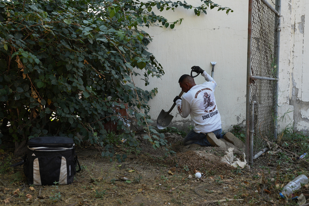 Raul Servin, whose son disappeared eight years prior, inspects an area where the Guerreros Buscadores group of serarchers suspects bodies may be buried, in Tlajomulco de Zuniga, on the outskirts of Guadalajara, Mexico, Tuesday, March 24, 2026. (AP Photo/Eduardo Verdugo)