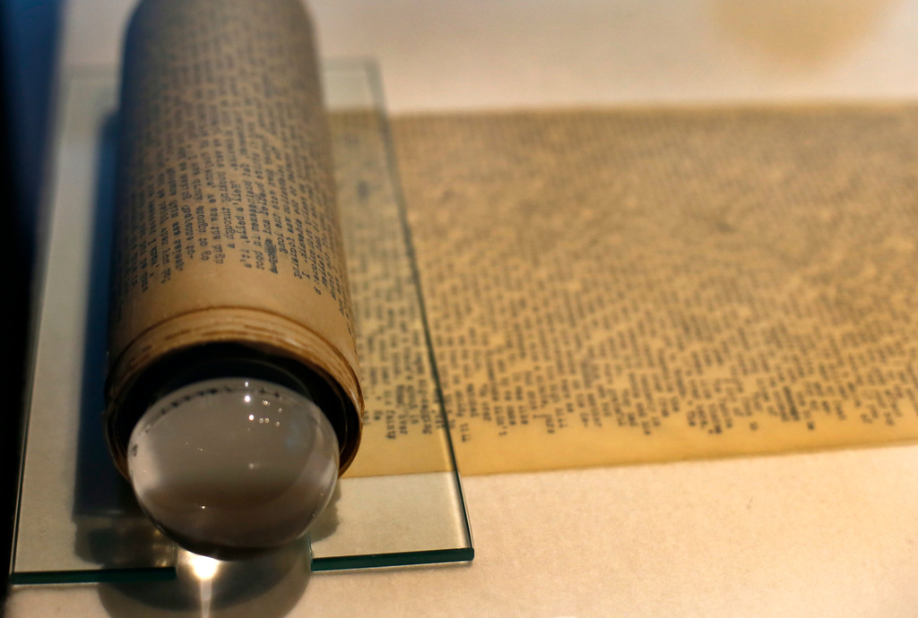 FILE - Jack Kerouac's "On the Road" and its working manuscript, the extraordinary 120-foot scroll he would unfurl before startled publishers, sits on display at the American Writers Museum in Chicago, May 8, 2017. (AP Photo/Charles Rex Arbogast, File)