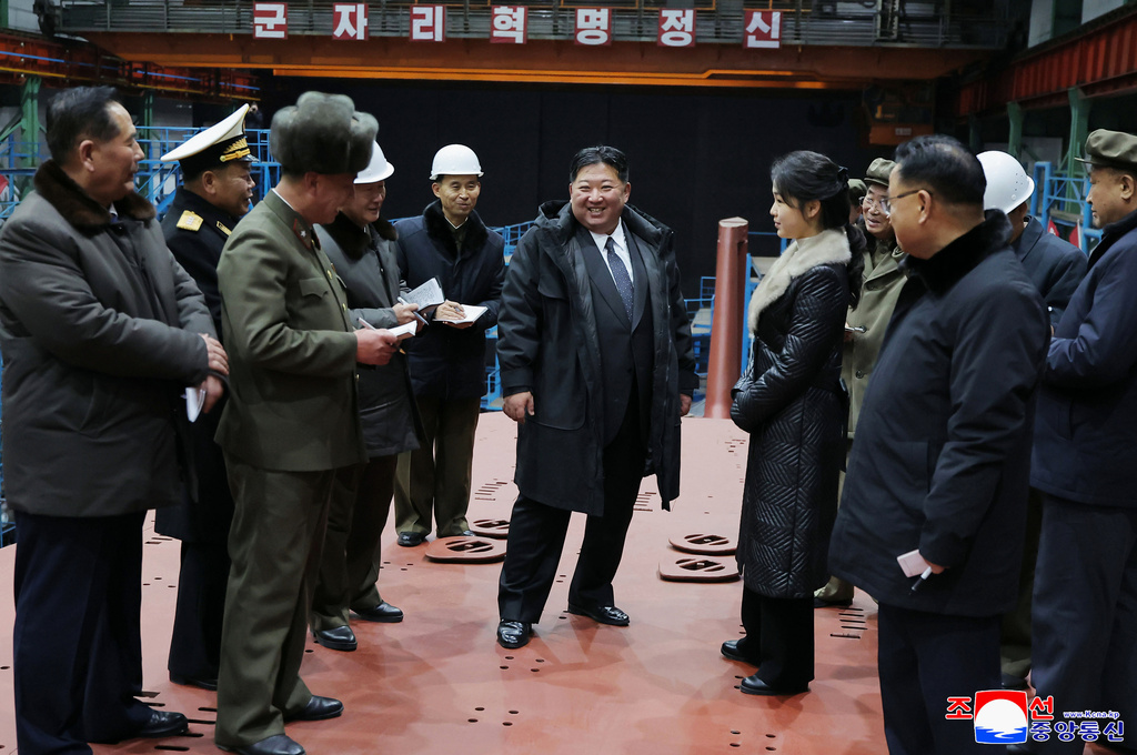 In this undated photo provided Thursday, Dec. 25, 2025, by the North Korean government, its leader Kim Jong Un, with his daughter, inspects a nuclear-powered submarine under construction at an undisclosed location in North Korea. Independent journalists were not given access to cover the event depicted in this image distributed by the North Korean government. The content of this image is as provided and cannot be independently verified. Korean language watermark on image as provided by source reads: "KCNA" which is the abbreviation for Korean Central News Agency. (Korean Central News Agency/Korea News Service via AP)