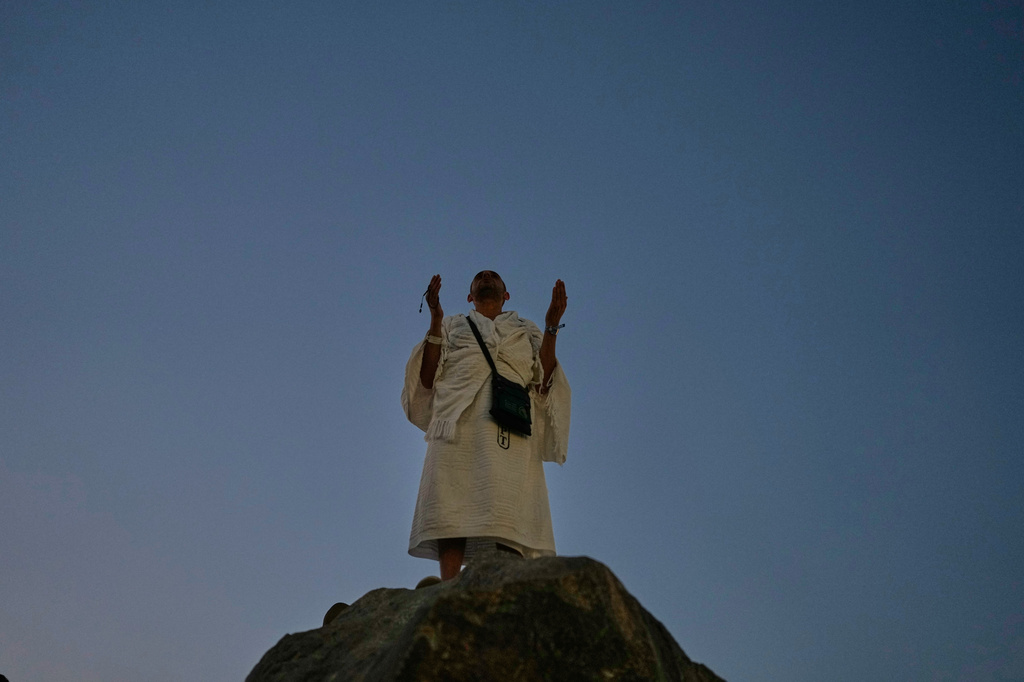 A Muslim pilgrim pray atop of the rocky hill known as the Mountain of Mercy, on the Plain of Arafat, during the annual Hajj pilgrimage near the holy city of Mecca, Saudi Arabia, Tuesday, May 26, 2026. (AP Photo/Altaf Qadri)