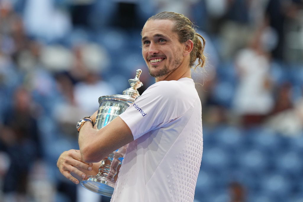 Alexander Zverev, of Germany, poses with the trophy after he won the men's singles final of the U.S. Open tennis championships against Ben Shelton, of the United States, Sunday, Sept. 13, 2026, in New York. (AP Photo/Kirsty Wigglesworth)