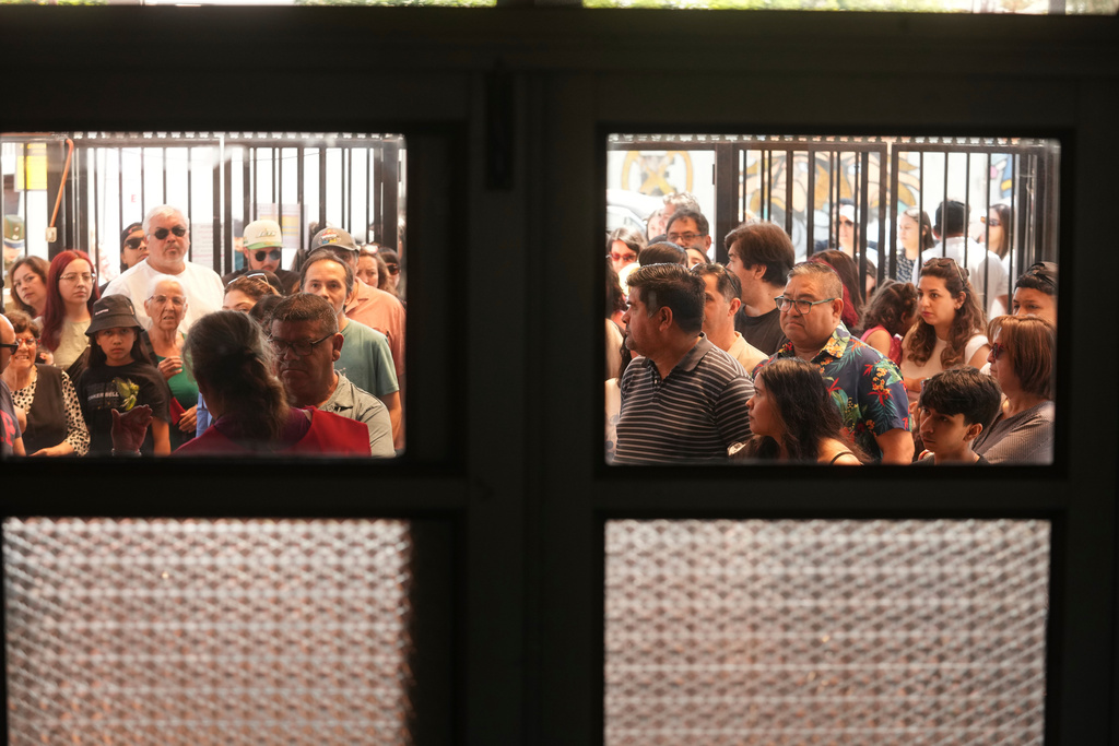 Voters line up at a polling station during general elections in Santiago, Chile, Sunday, Nov. 16, 2025. (AP Photo/Esteban Felix)